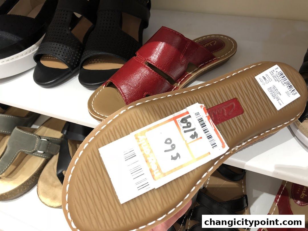 Close-up of Clarks sandals on display, with price tags visible.