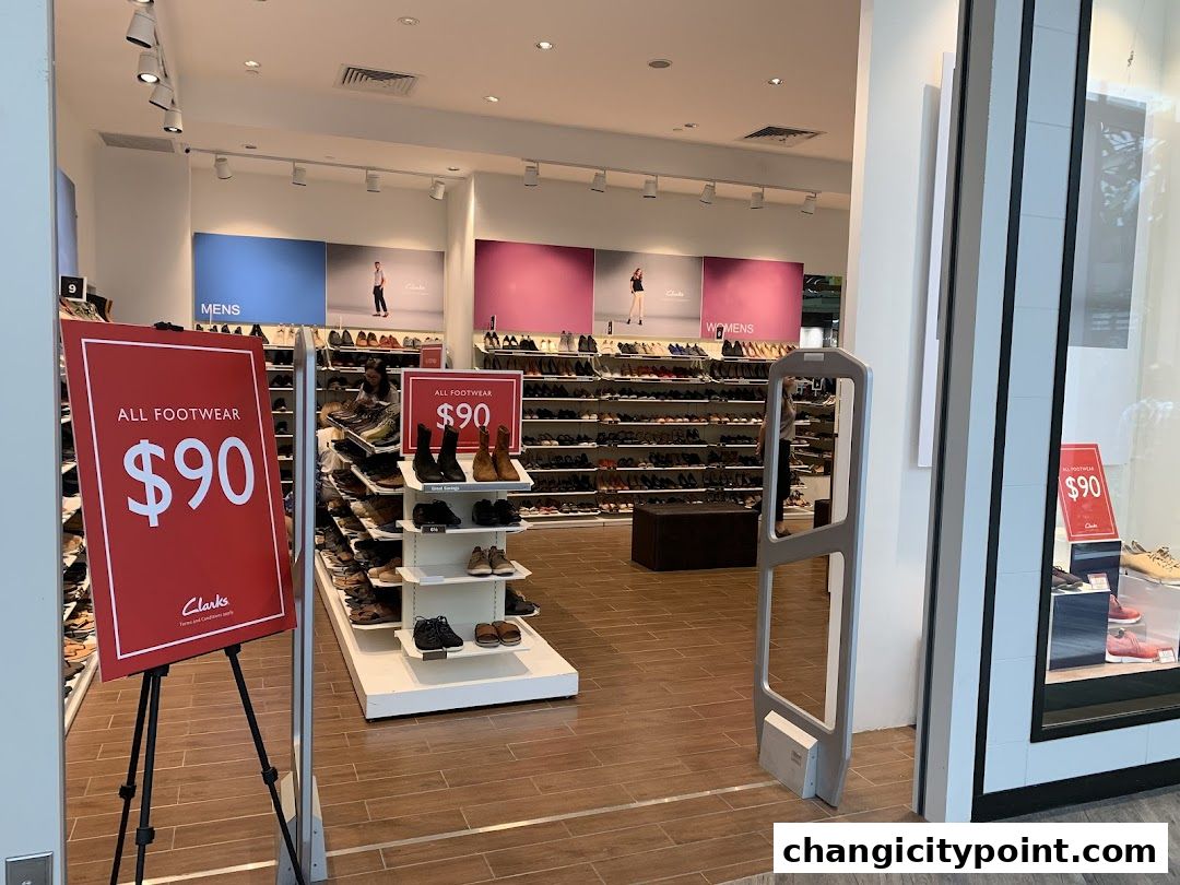 Clarks Outlet store interior with shoes displayed and sale signs.