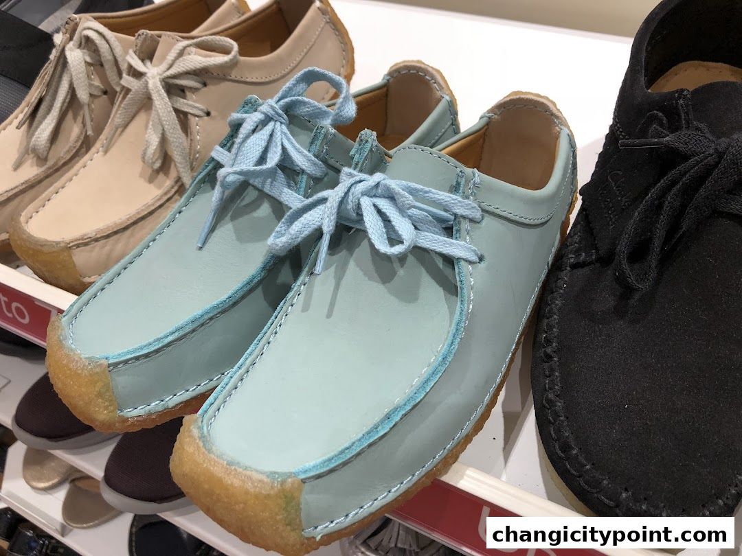 A close-up view of several pairs of Clarks shoes in various colors on display.