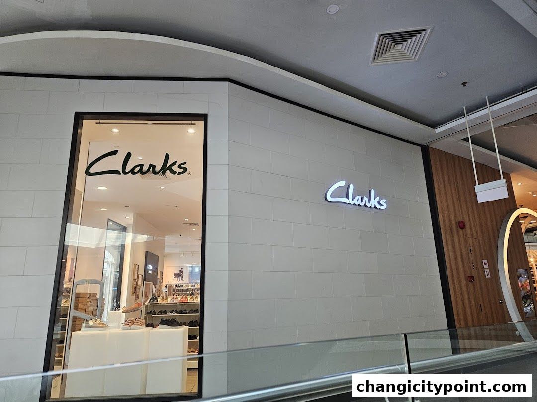 The exterior of a Clarks Outlet store with its logo visible on the facade and window.