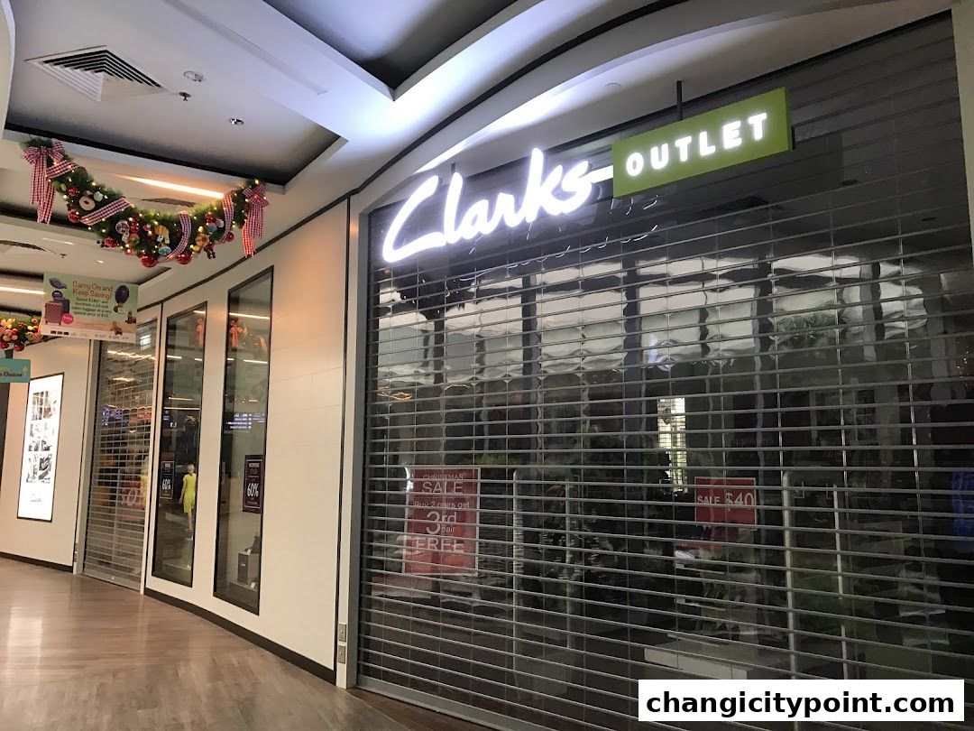 Clarks Outlet store with closed shutters and Christmas decorations.