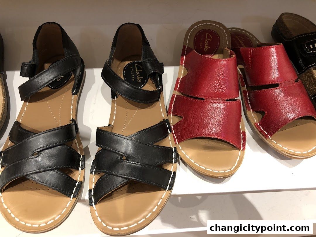 A display of black and red leather sandals from Clarks Outlet.