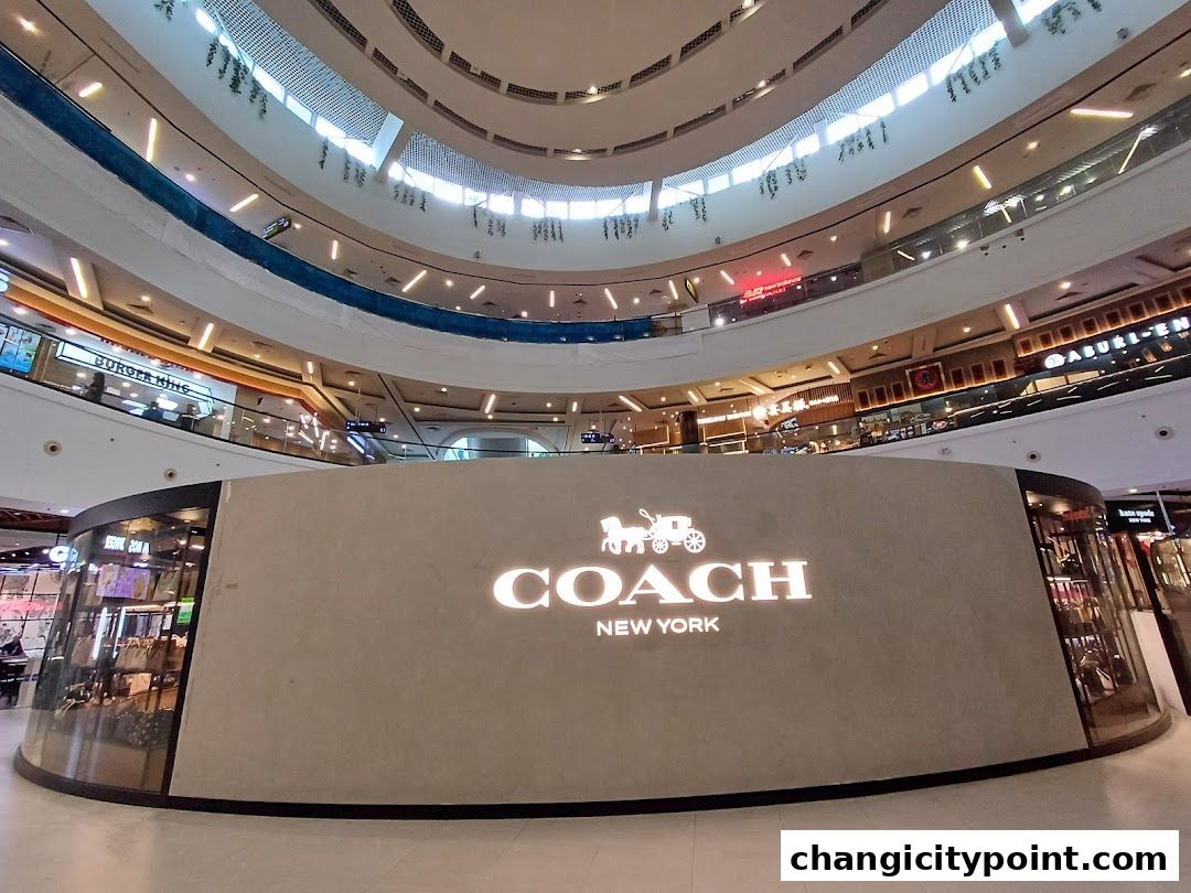 The Coach New York store entrance with its iconic logo prominently displayed.
