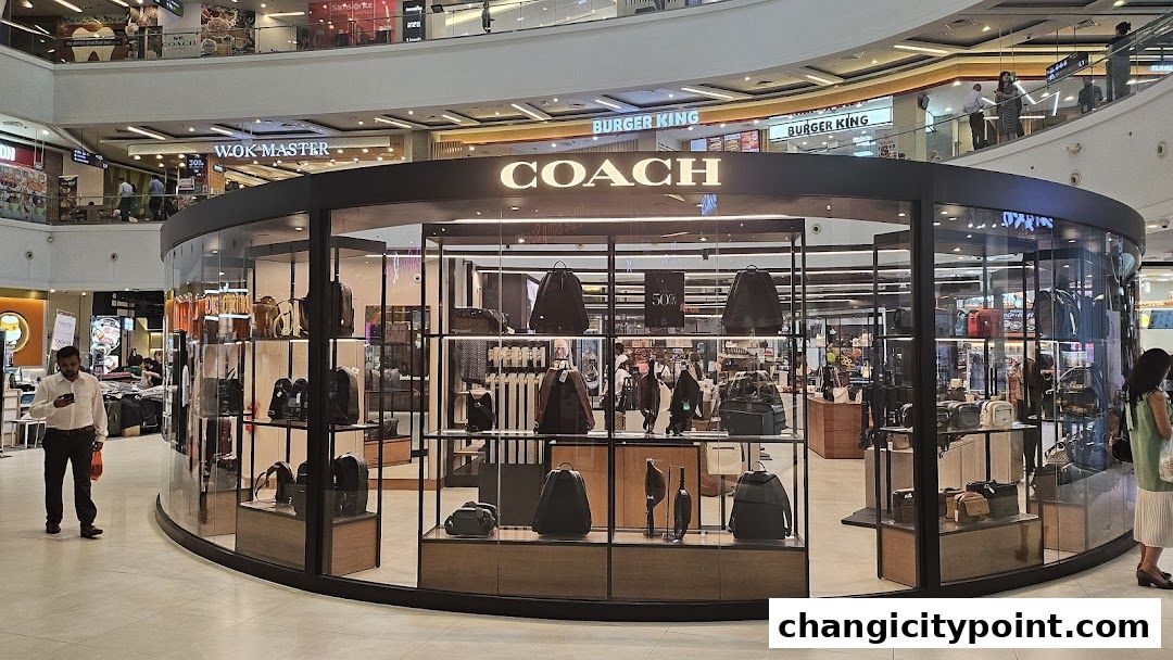 Coach Outlet store interior showcasing various handbags and accessories on display shelves.