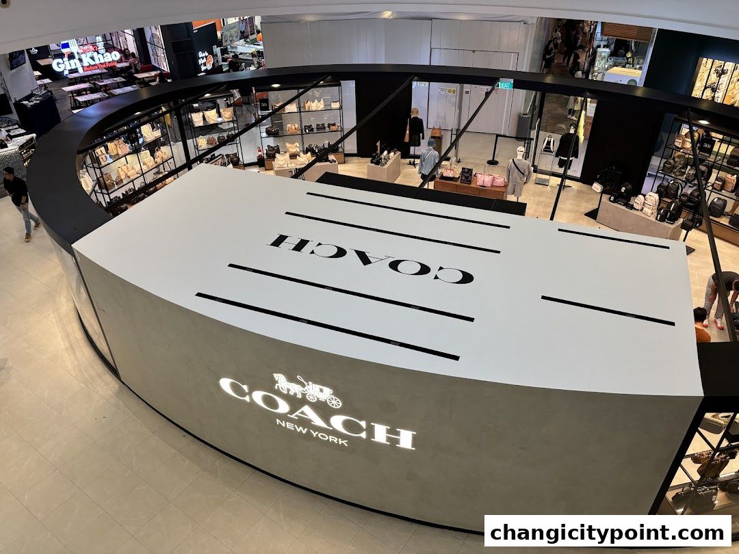 Coach Outlet store interior showcasing handbags and accessories with prominent branding.