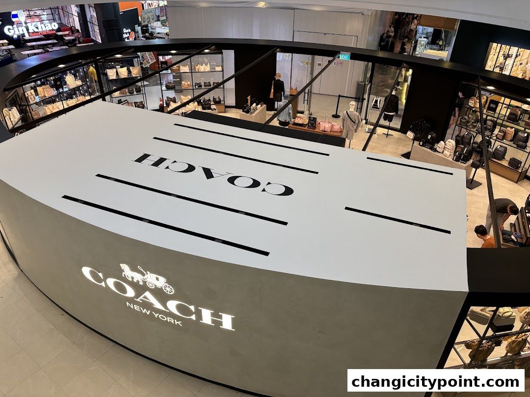 Coach Outlet store interior with bags displayed and prominent branding.