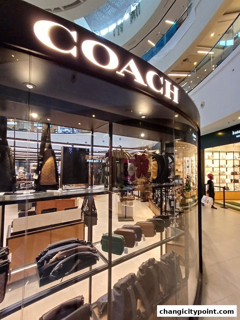 Coach Outlet store interior showcasing various handbags and accessories on display.