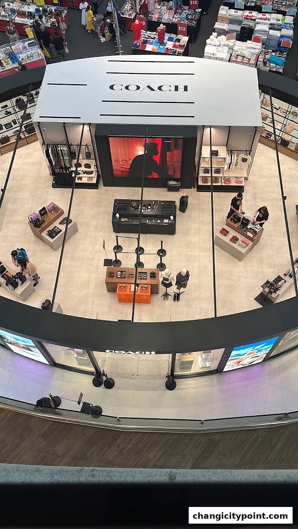 Aerial view of a Coach Outlet store showcasing handbags, apparel, and accessories.