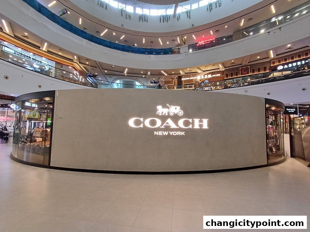 The Coach Outlet store entrance with its iconic logo and display windows.