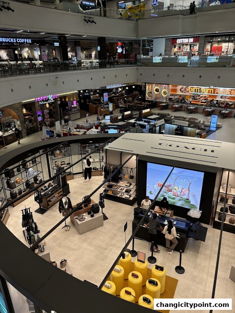 Coach Outlet store interior showcasing handbags, accessories, and apparel on display.