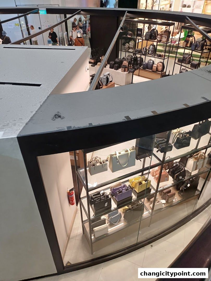 A display of various handbags and backpacks inside a retail store.