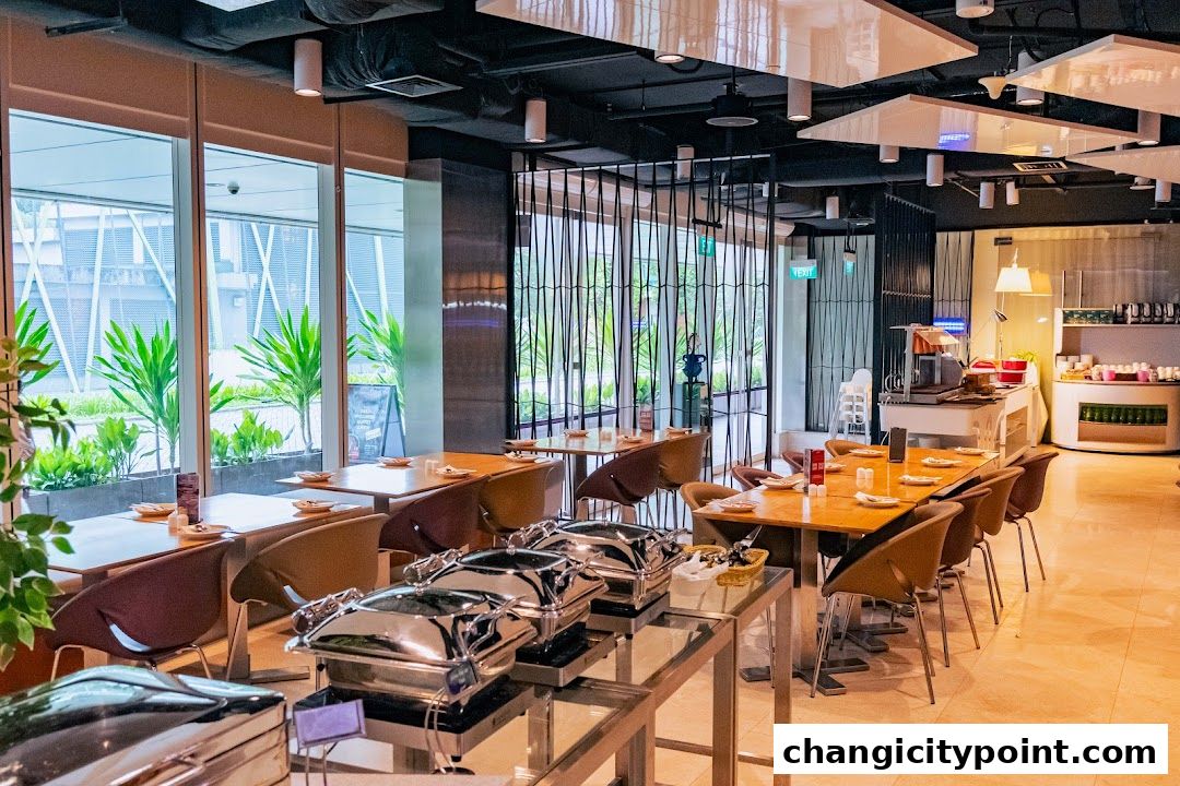 Interior of a restaurant with dining tables, buffet stations, and large windows.