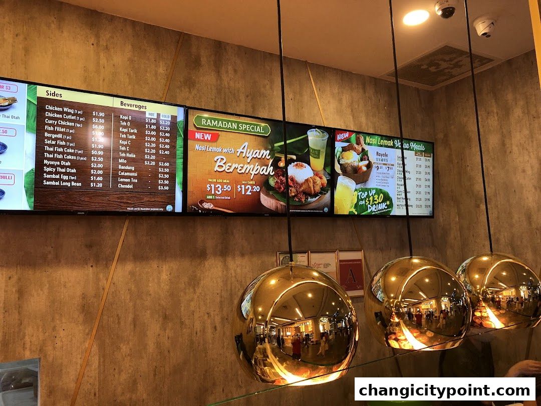 Digital menu boards displaying Nasi Lemak meals, sides, and beverages.