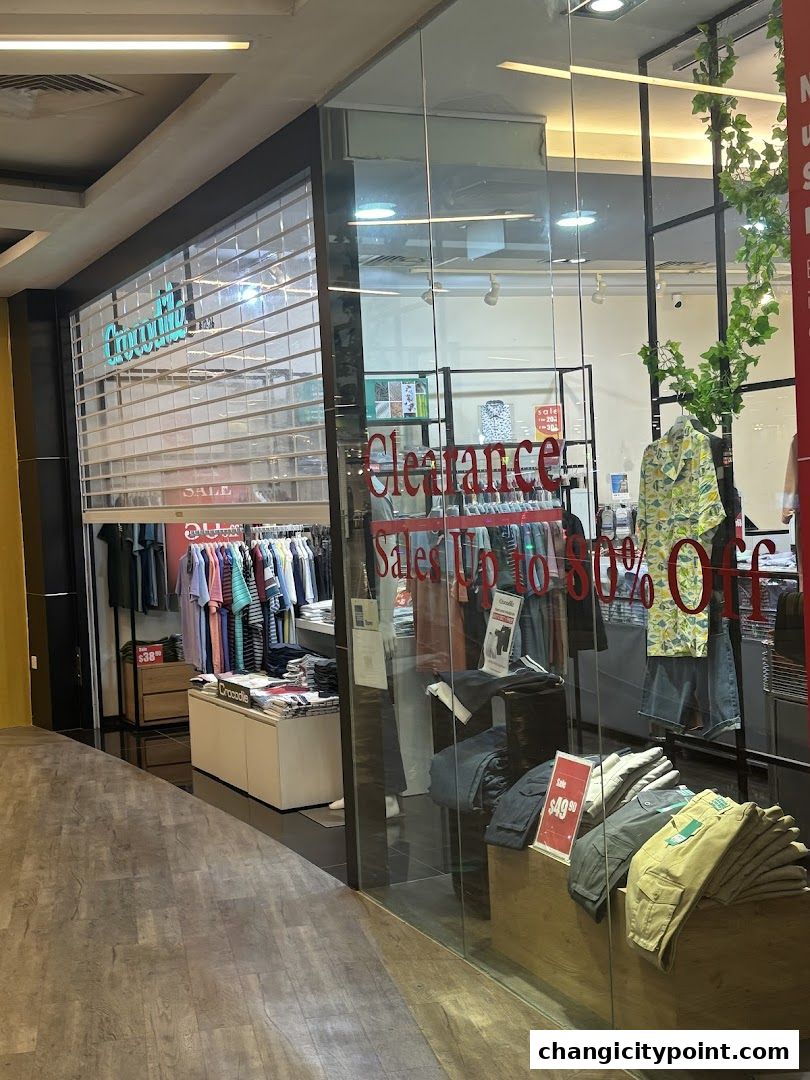 Crocodile Outlet shop front with clearance sale signs and clothing displays.