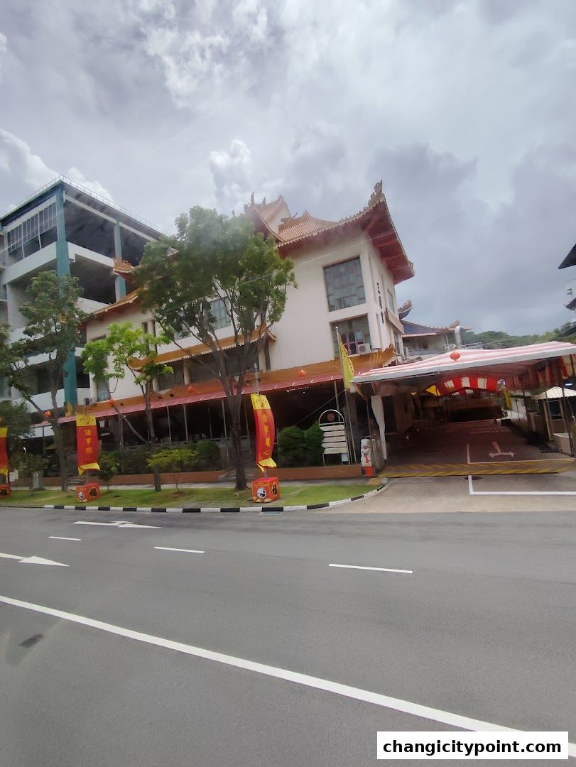 A traditional building with ornate roofs, adorned with red banners and flags.