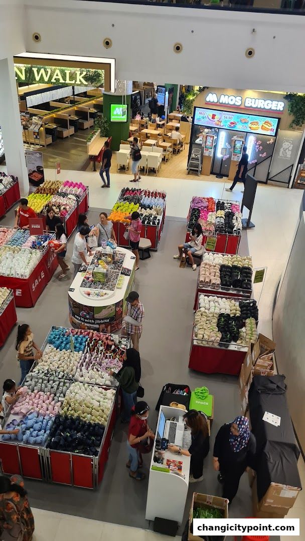 An overhead view of a Crocs outlet store with many colorful shoes displayed.
