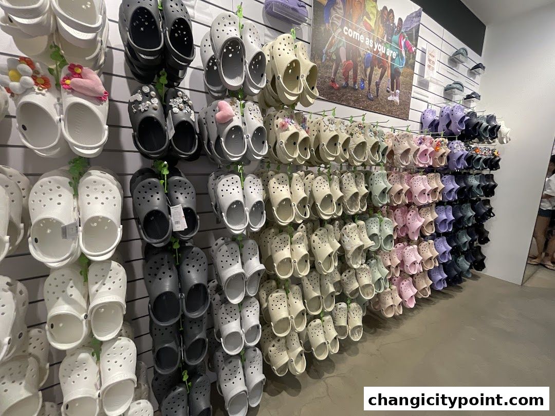 A wall display of various Crocs shoes in multiple colors and styles.