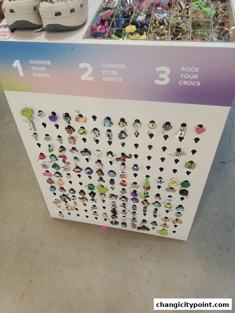 A display of Jibbitz charms for Crocs shoes, with instructions to choose clogs, Jibbitz, and rock your Crocs.