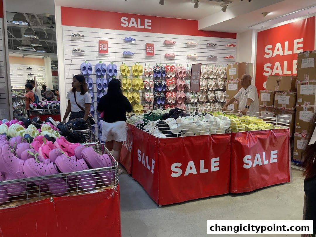 Crocs Outlet store interior with colorful clogs and sale signs.