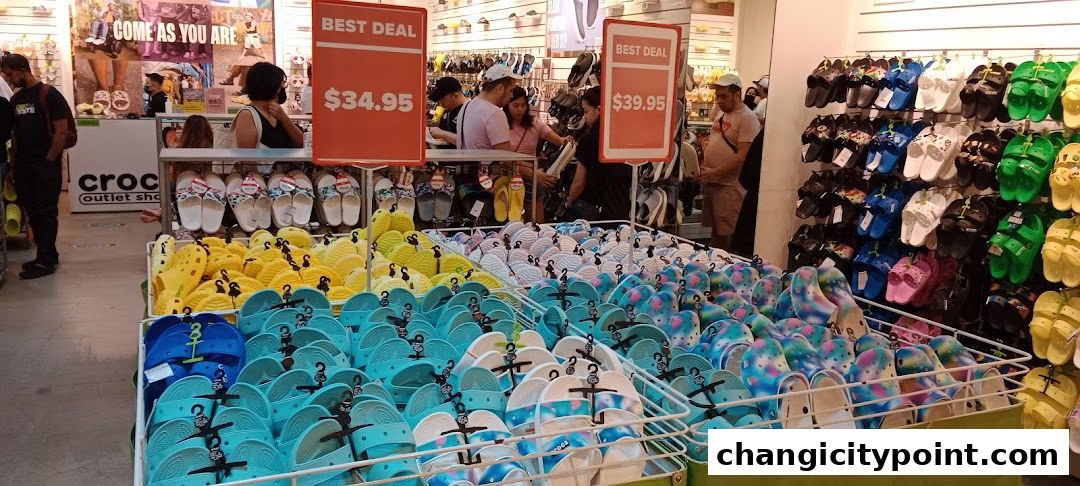 A Crocs Outlet store displaying a wide variety of colorful clogs and sandals on shelves and in bins.