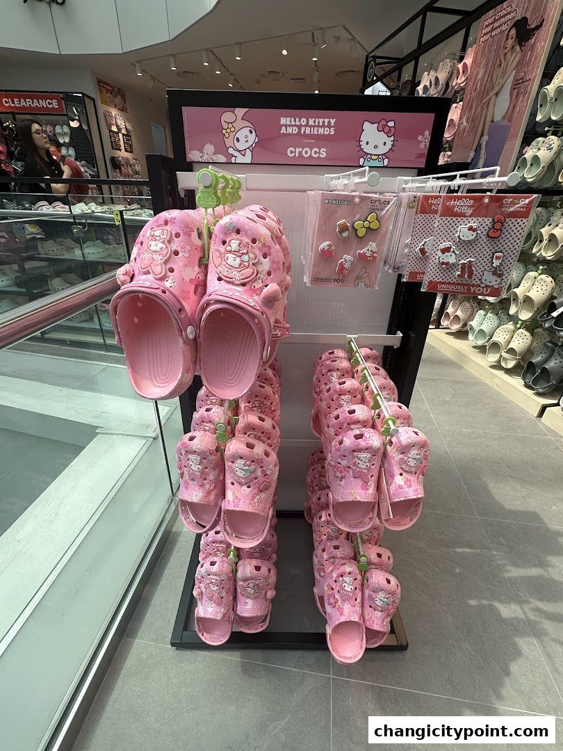 Pink Crocs featuring Hello Kitty and Friends designs, displayed with Jibbitz charms.
