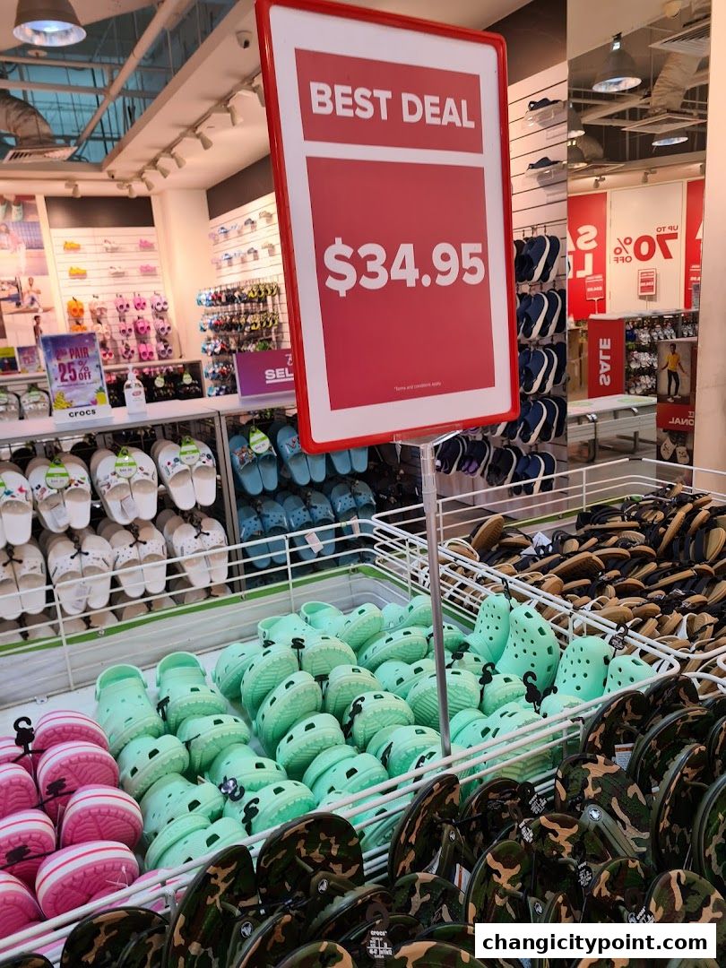 Crocs outlet store with a 'Best Deal' sign and various colorful Crocs shoes on display.