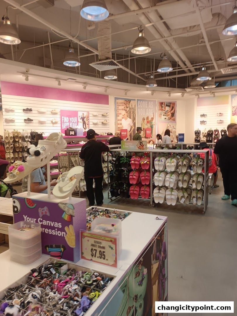 Interior view of a Crocs store showcasing various footwear and accessories, with a focus on customization.