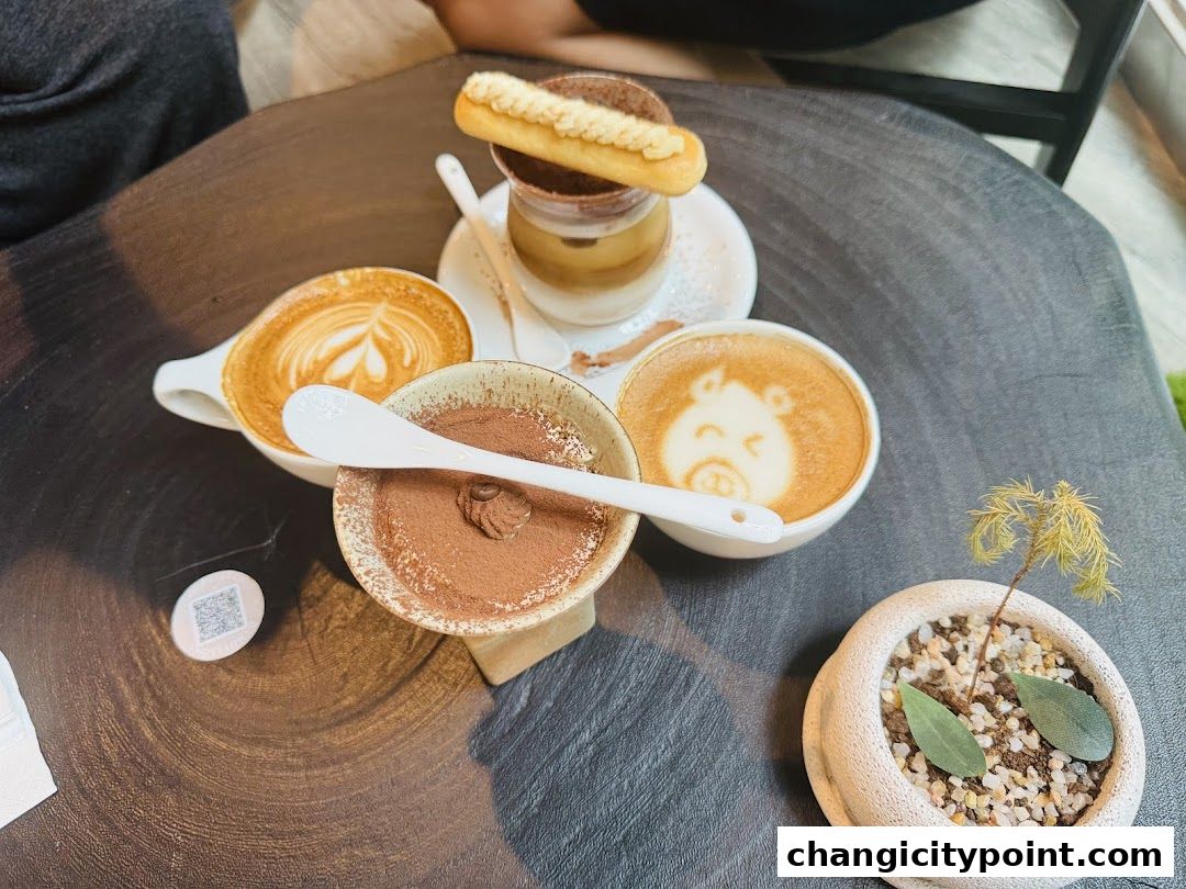 A table setting with coffee, tiramisu, and a small potted plant.