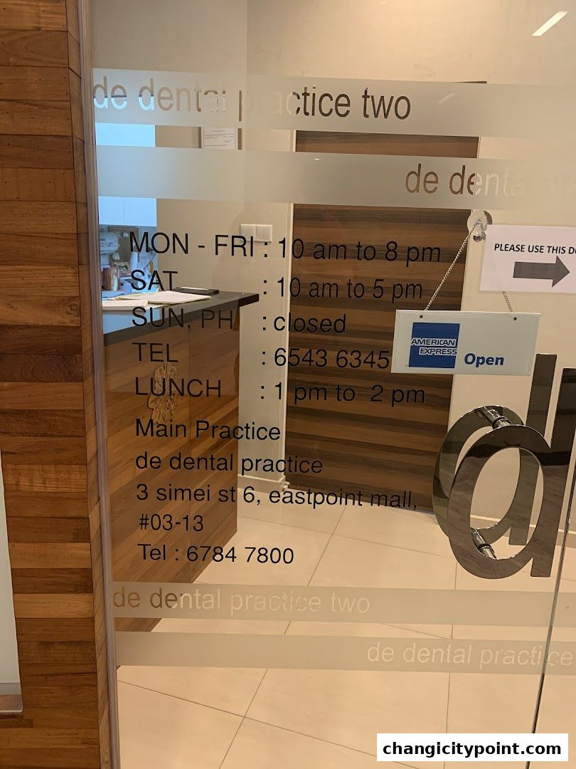 The entrance of De Dental Practice Two Ltd, showing operating hours and contact information.
