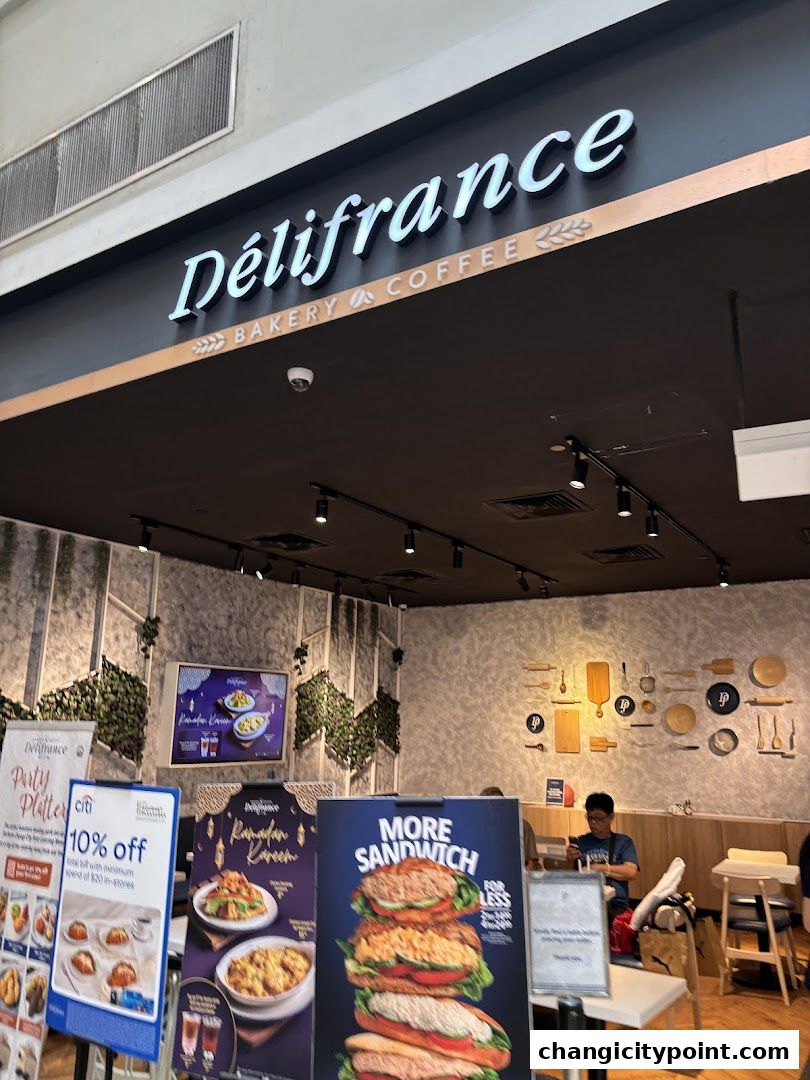 Exterior view of Delifrance bakery and coffee shop with promotional posters.