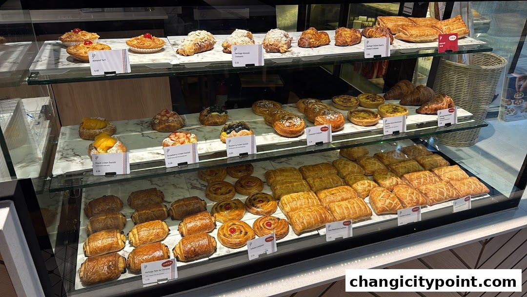 A display case filled with a variety of freshly baked pastries and tarts.