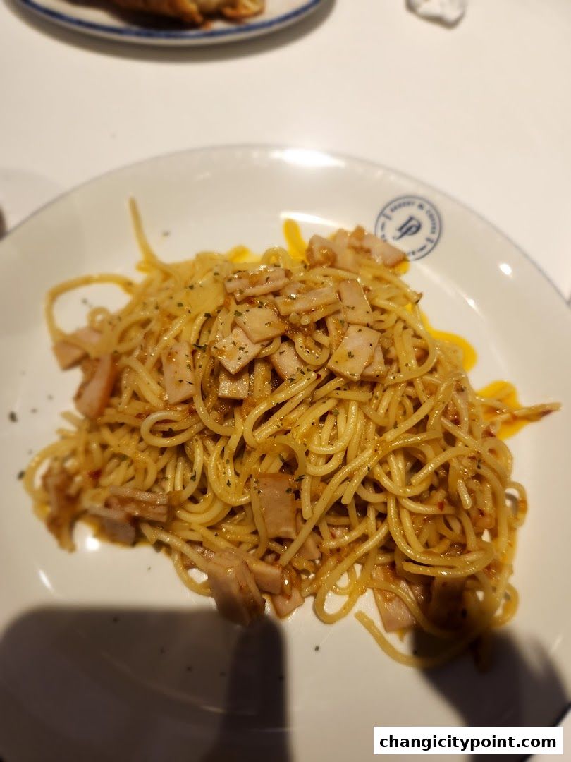 A plate of spaghetti with ham and a creamy sauce, served at Delifrance.