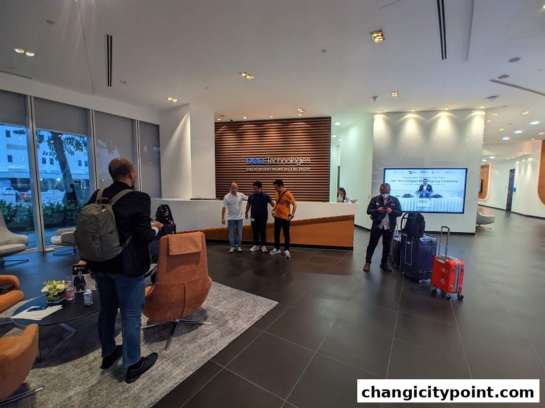 Interior of a modern Dell Technologies office with a reception area and digital display.