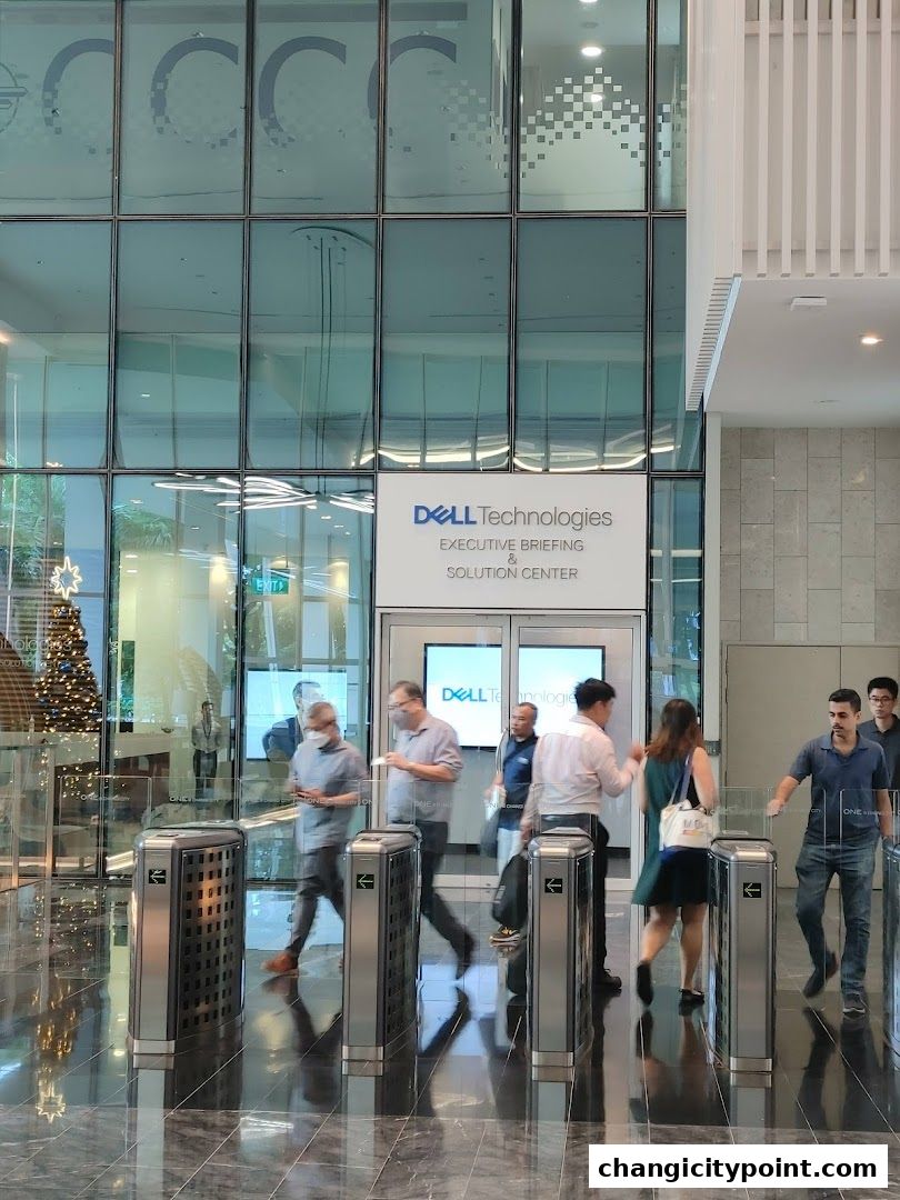 Entrance to Dell Technologies Executive Briefing & Solution Center with people passing through turnstiles.