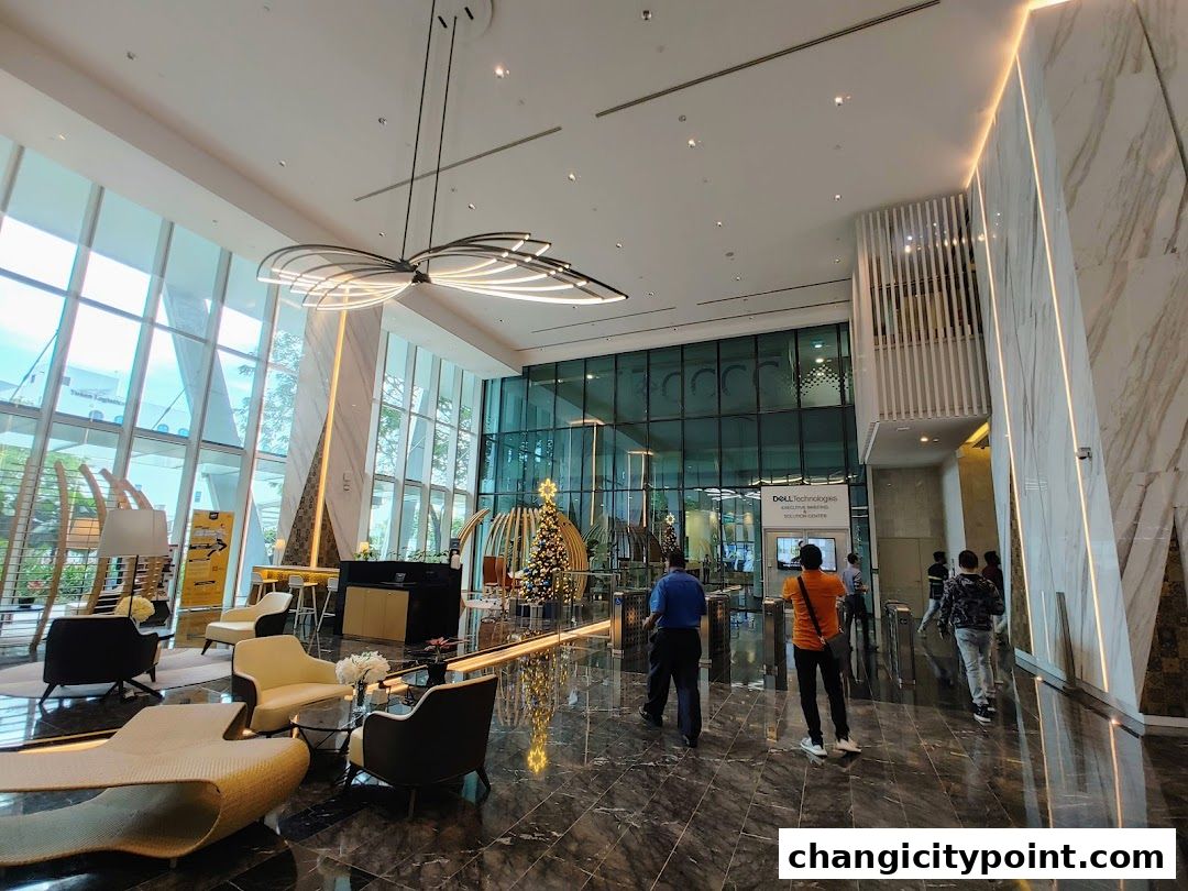Modern office lobby with seating, a Christmas tree, and a sign for Dell Technologies.