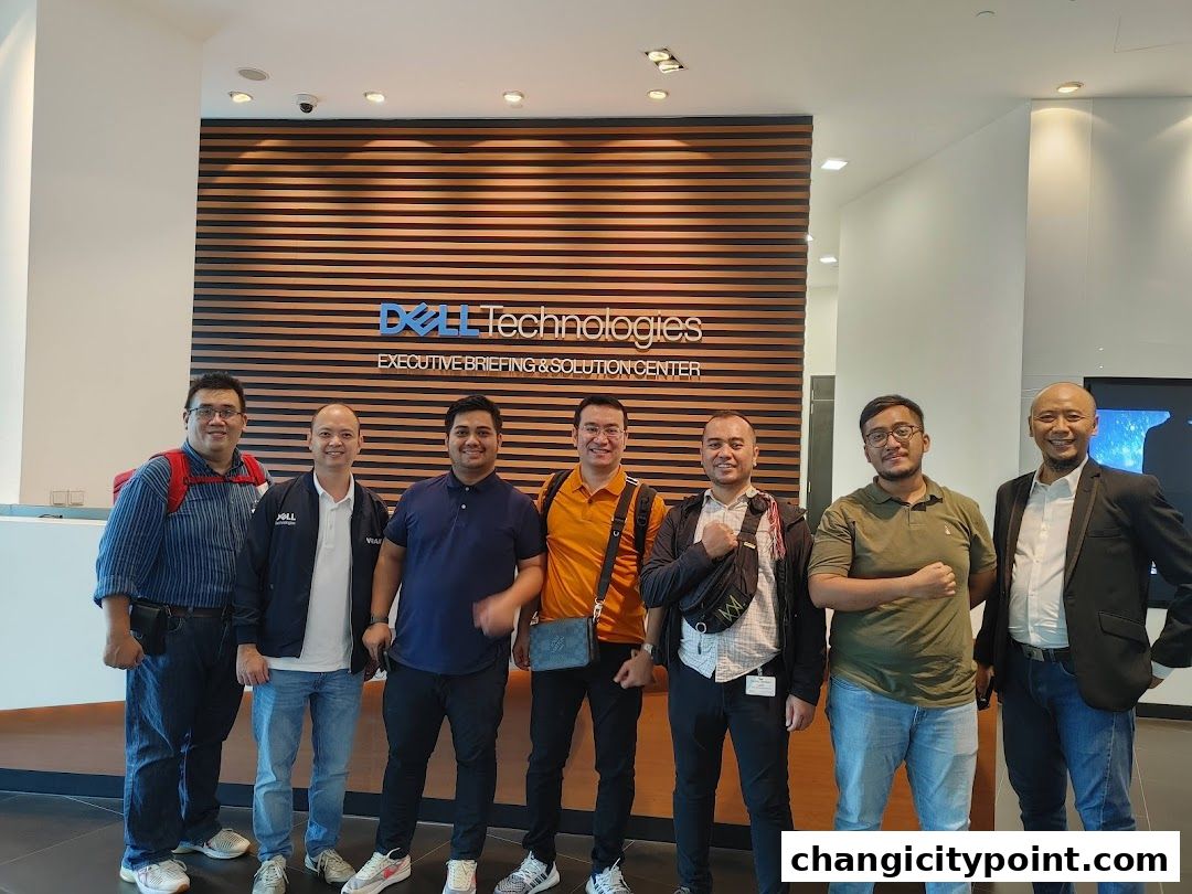 A group of men pose in front of the Dell Technologies Executive Briefing & Solution Center.