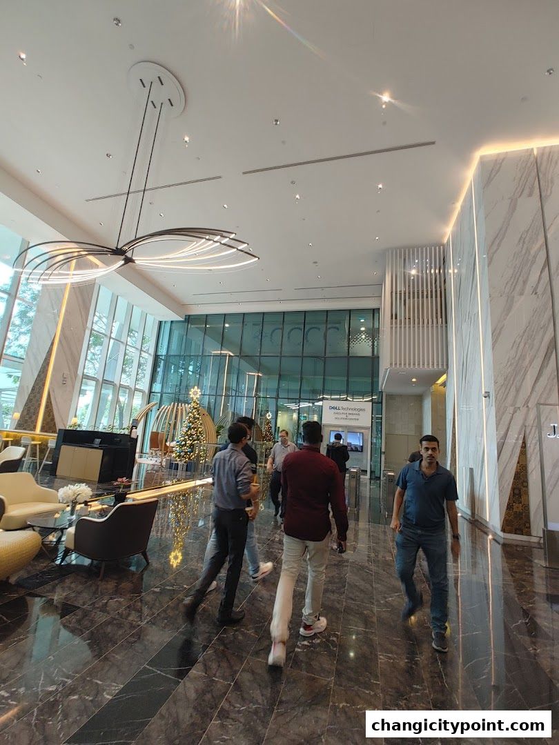 Modern office lobby with marble floors, contemporary lighting, and a Dell Technologies display.
