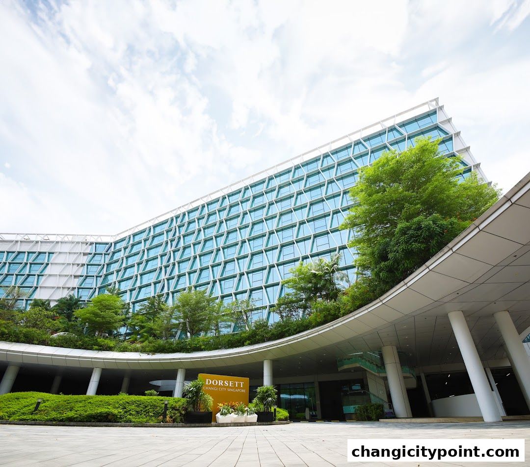 Exterior view of Dorsett Changi City Singapore hotel with modern architecture and lush greenery.