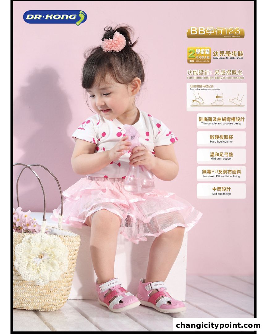 A young child wearing pink shoes and a cherry-print top, holding a spray bottle.