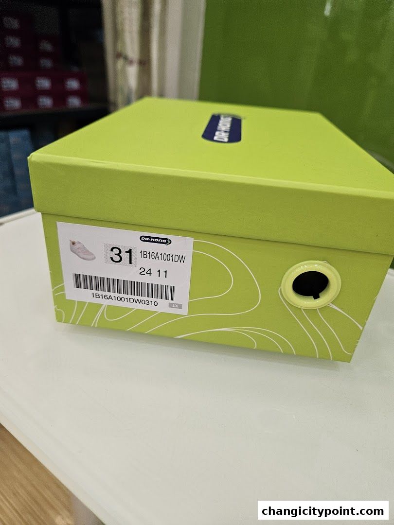 A bright green shoe box from Dr. Kong with a label showing size and product details.