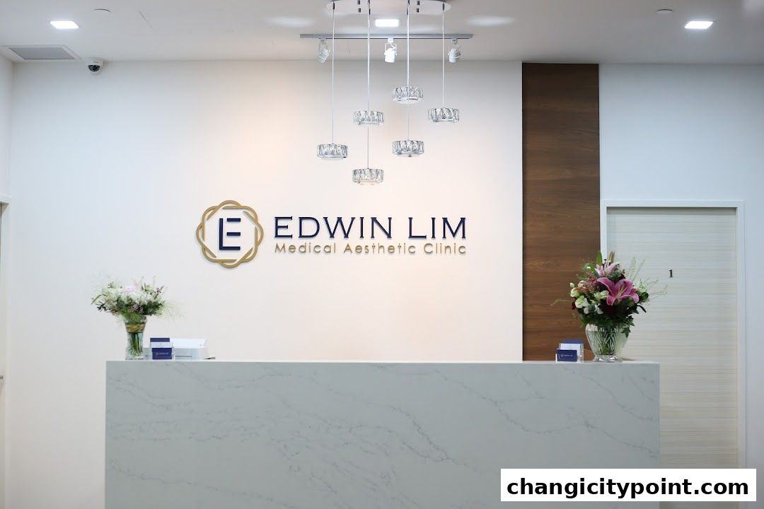 Reception area of Edwin Lim Medical Aesthetic Clinic with logo and floral arrangements.