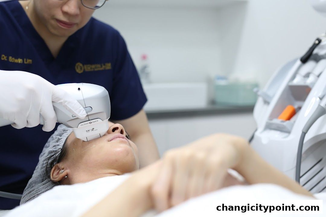 Doctor performing a facial treatment with a device on a patient.