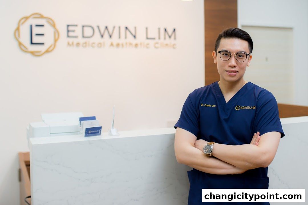 A doctor in scrubs stands in front of the Edwin Lim Medical Aesthetic Clinic reception.