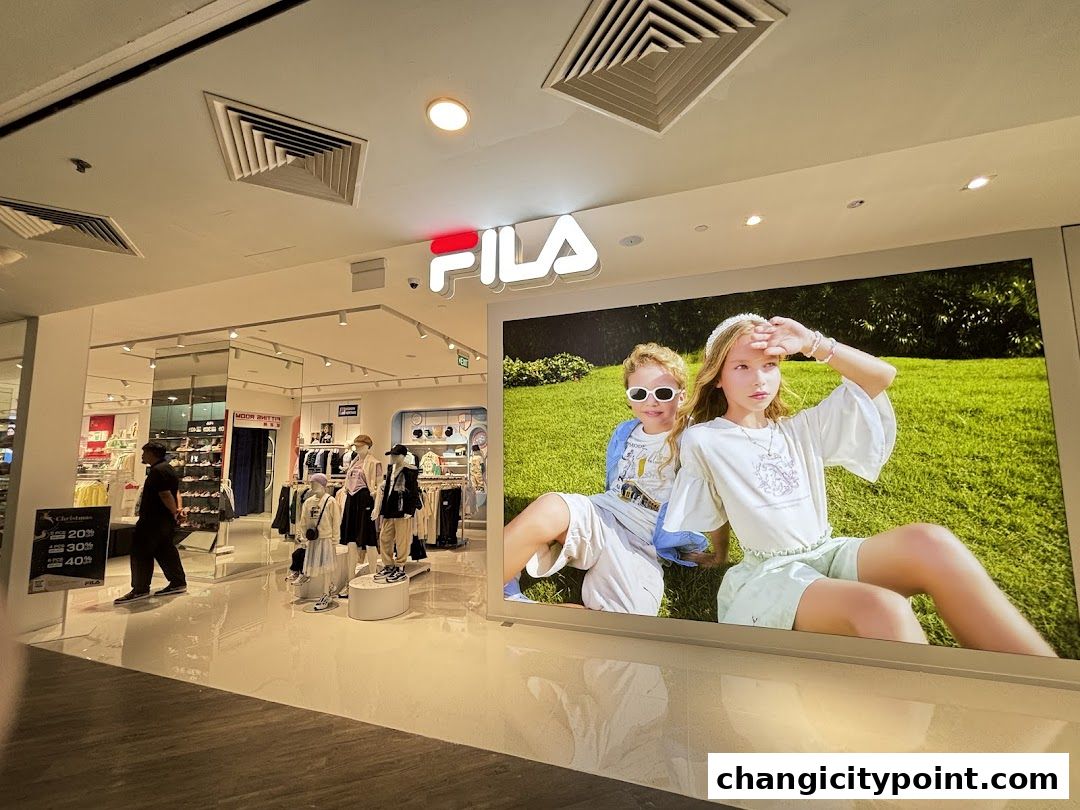 FILA Outlet store entrance with a large display of children wearing FILA apparel.