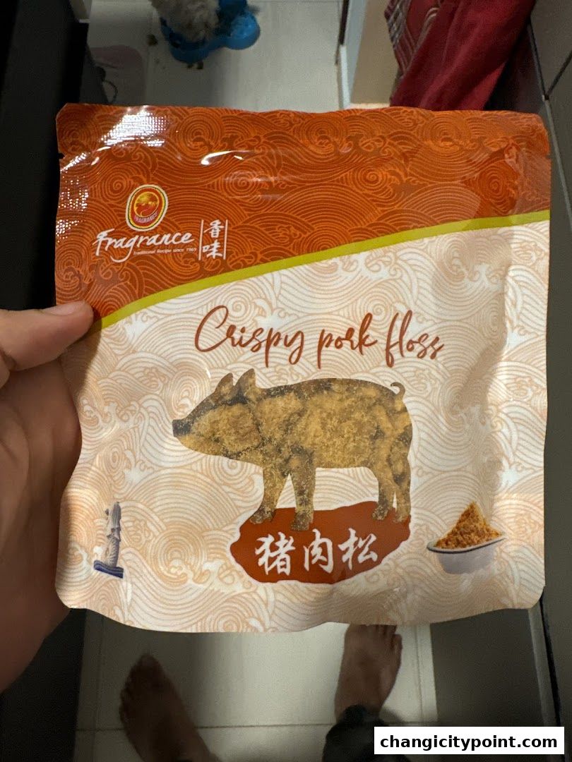 A package of Fragrance Crispy Pork Floss with Chinese characters and a pig illustration.