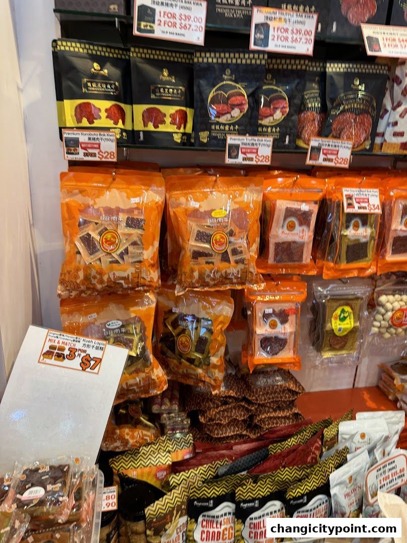 A display of various packaged bak kwa and other snacks in a retail shop.