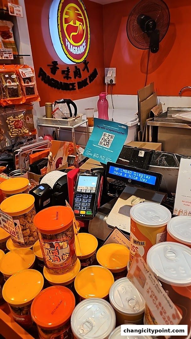 A counter display of various packaged bak kwa and snacks at Fragrance Bak Kwa.