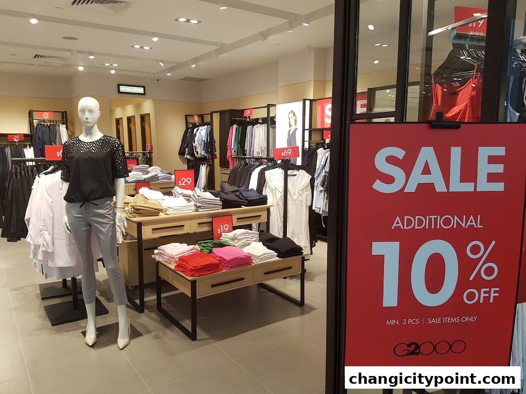 A G2000 store interior with clothing displays and a large sale sign.