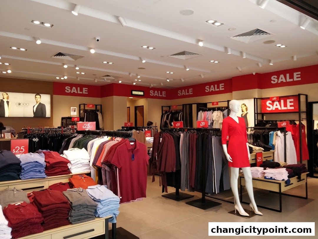 Interior of a G2000 clothing store with sale signs and mannequins.
