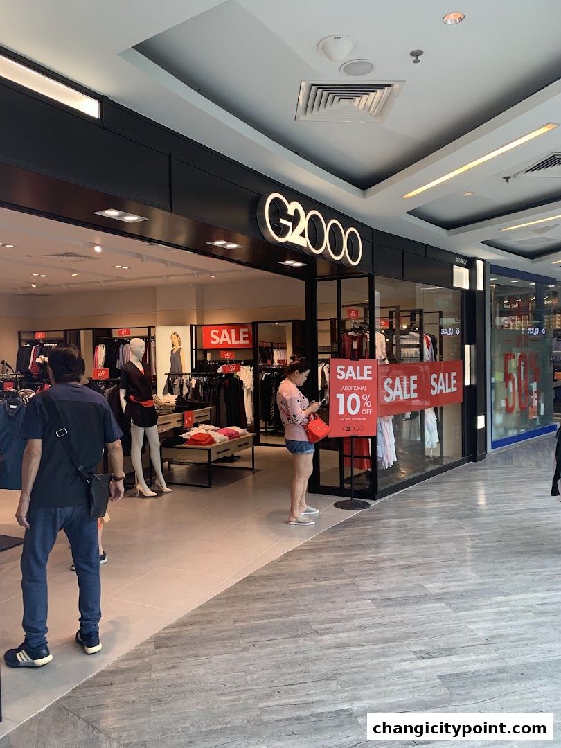 G2000 shop front with sale signs and mannequins displaying clothing.